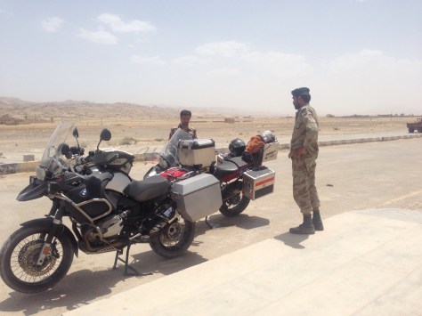 Stopped at a Pakistan military check point in the desert. Looks hot? Yes it was.