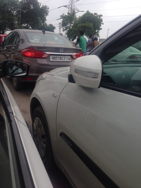 No this is not a parking lot, it's typical Delhi traffic, note the folded back mirrors. Who needs them?