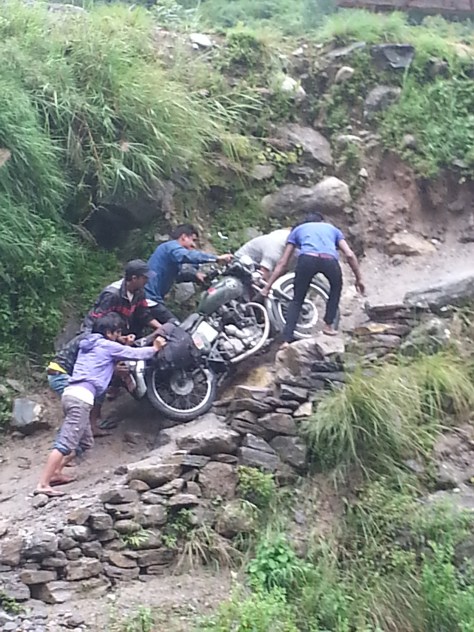 Having to pay locals to carry the bikes up the hillside due to impassable roads