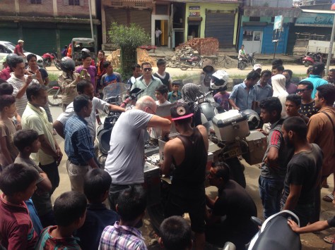 Steve fitting up the new bracket to his bike with a small crowd onlooking